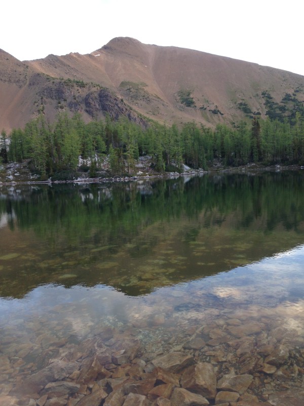 A waterfront tent no less. Mt. Brewer stands in the  Background.